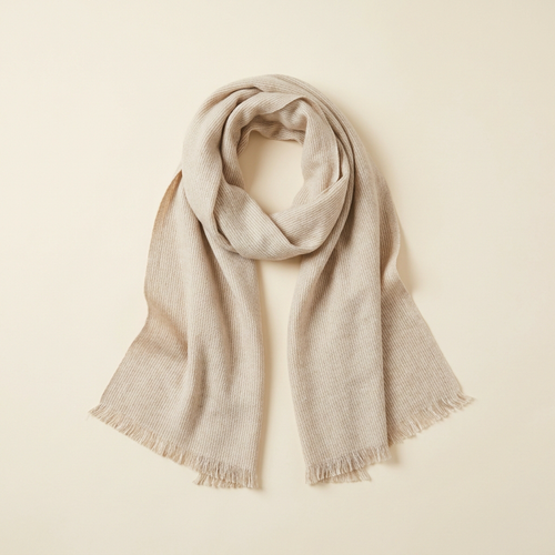Elena everyday long scarf in oatmeal with fringed ends, arranged on a cream studio backdrop
