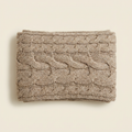 Marta cable knit blanket scarf in oatmeal taupe, folded on a cream studio backdrop